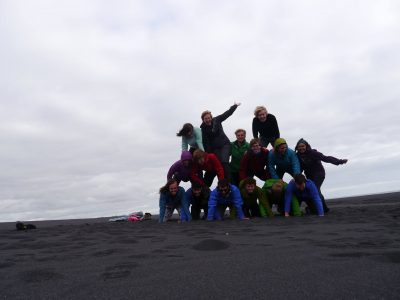 Unsuccessful human pyramid attempt on the wide black sands of an infinite beach, A Waldron
